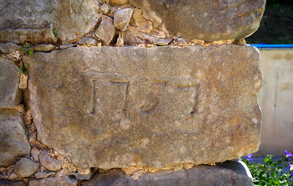 Carved 1757 date stone set into the old mill wall