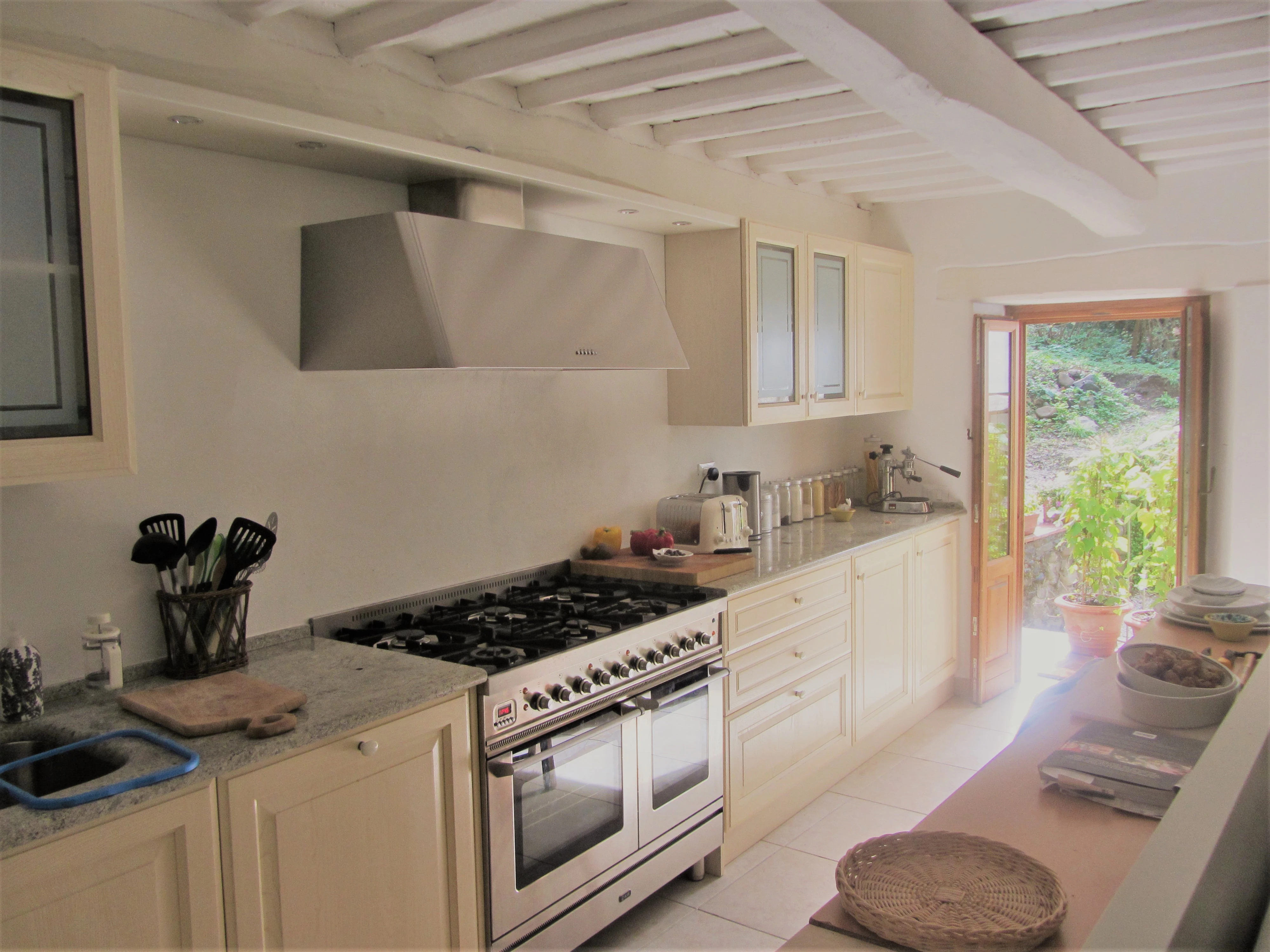 Bright country kitchen with breakfast bar and garden doors